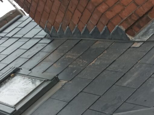 This is a photo of replaced lead flashing near a chimney stack. The work was done by Hinckley Roofing